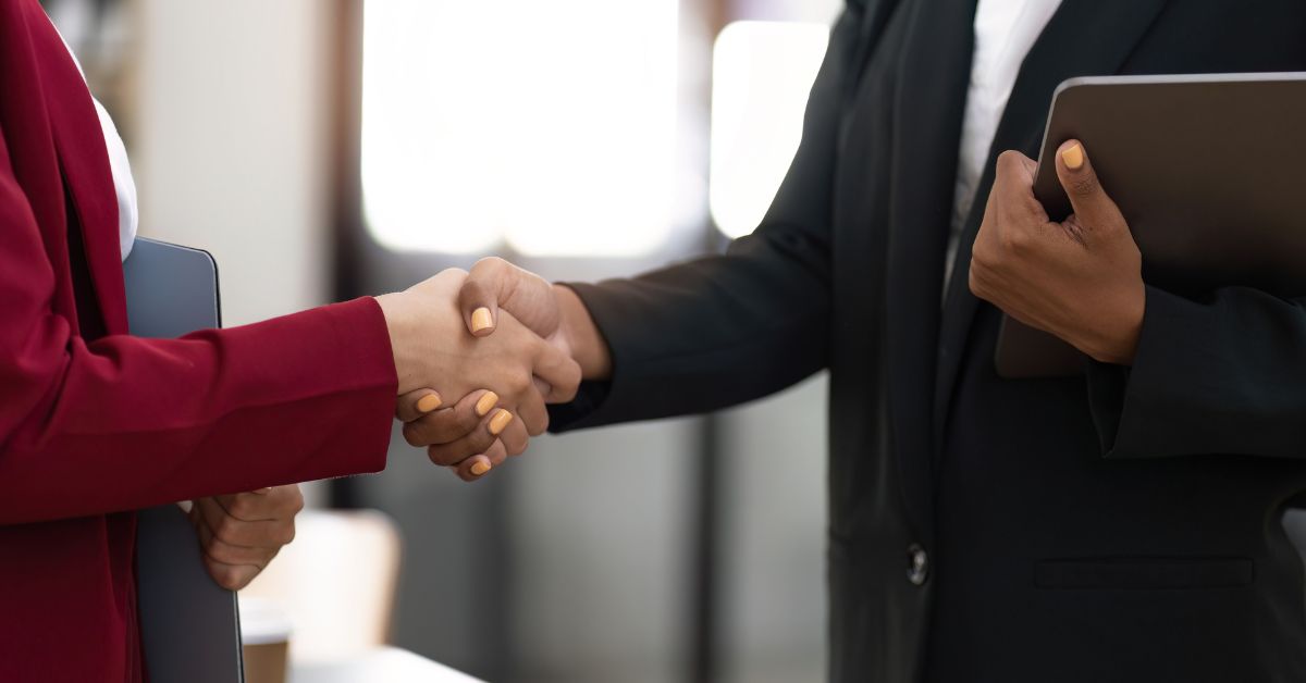 Two-women-shaking-hands-at-work.jpg